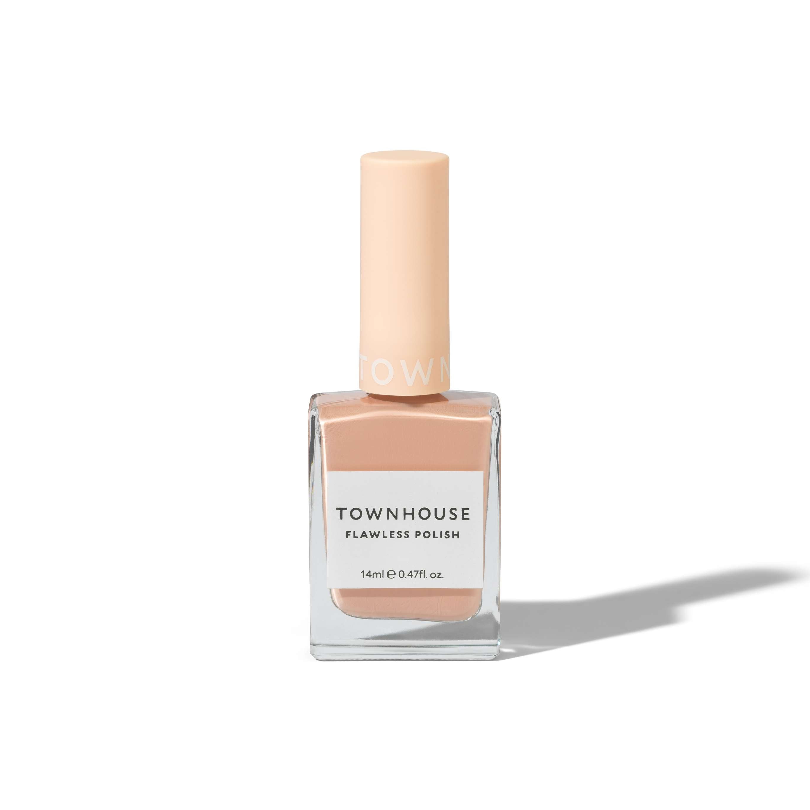 A bottle of TH - Milk Tea Polish 14ml, a perfect choice for those seeking a neutral nail polish in a light peach shade, is placed upright on a white background with a soft shadow to the right.