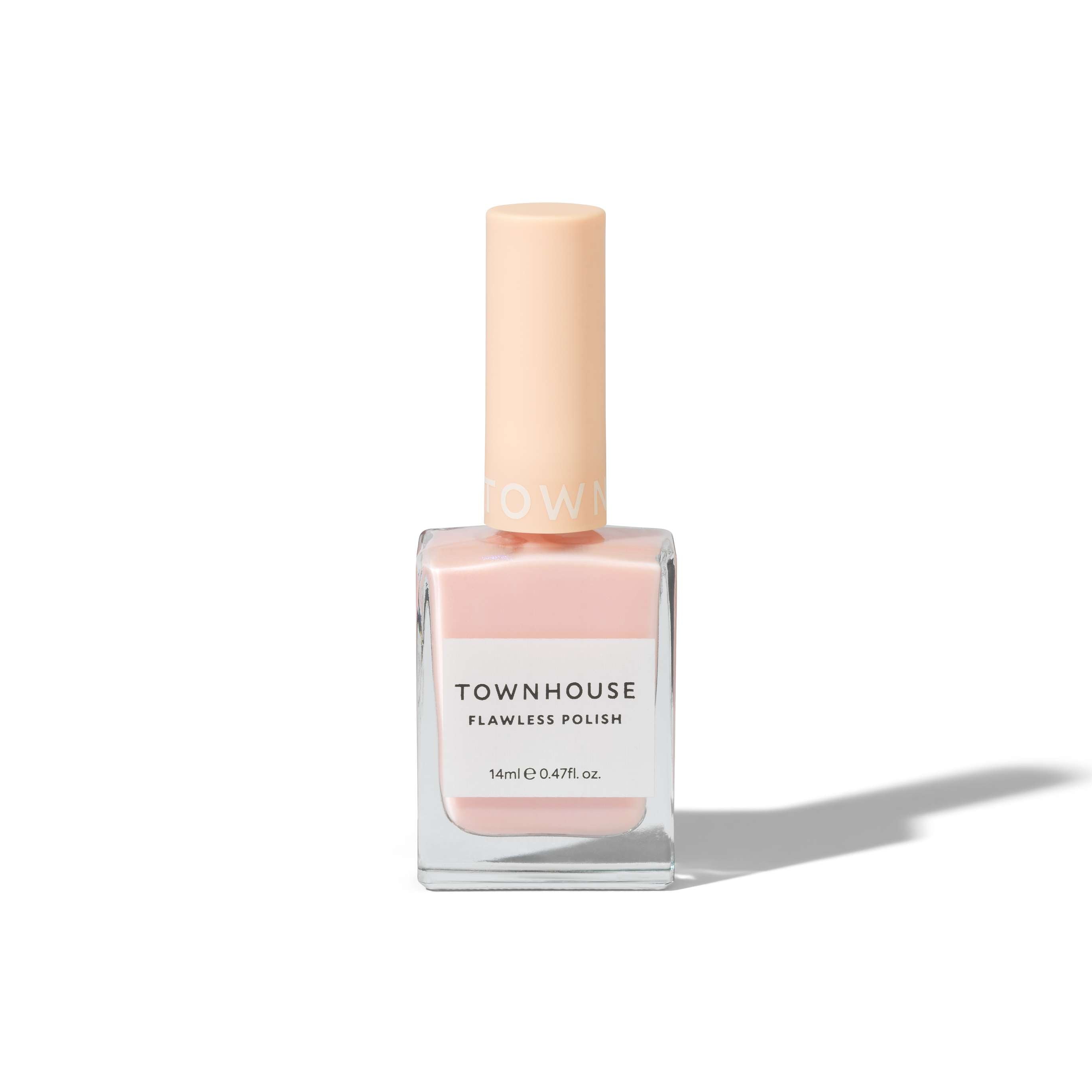 A bottle of TH - Glazed Strawberry Milk Polish 14ml stands upright on a white background with a soft shadow; it features a beautiful shimmer blush pink shade, housed in a square glass container with a pale peach cap.