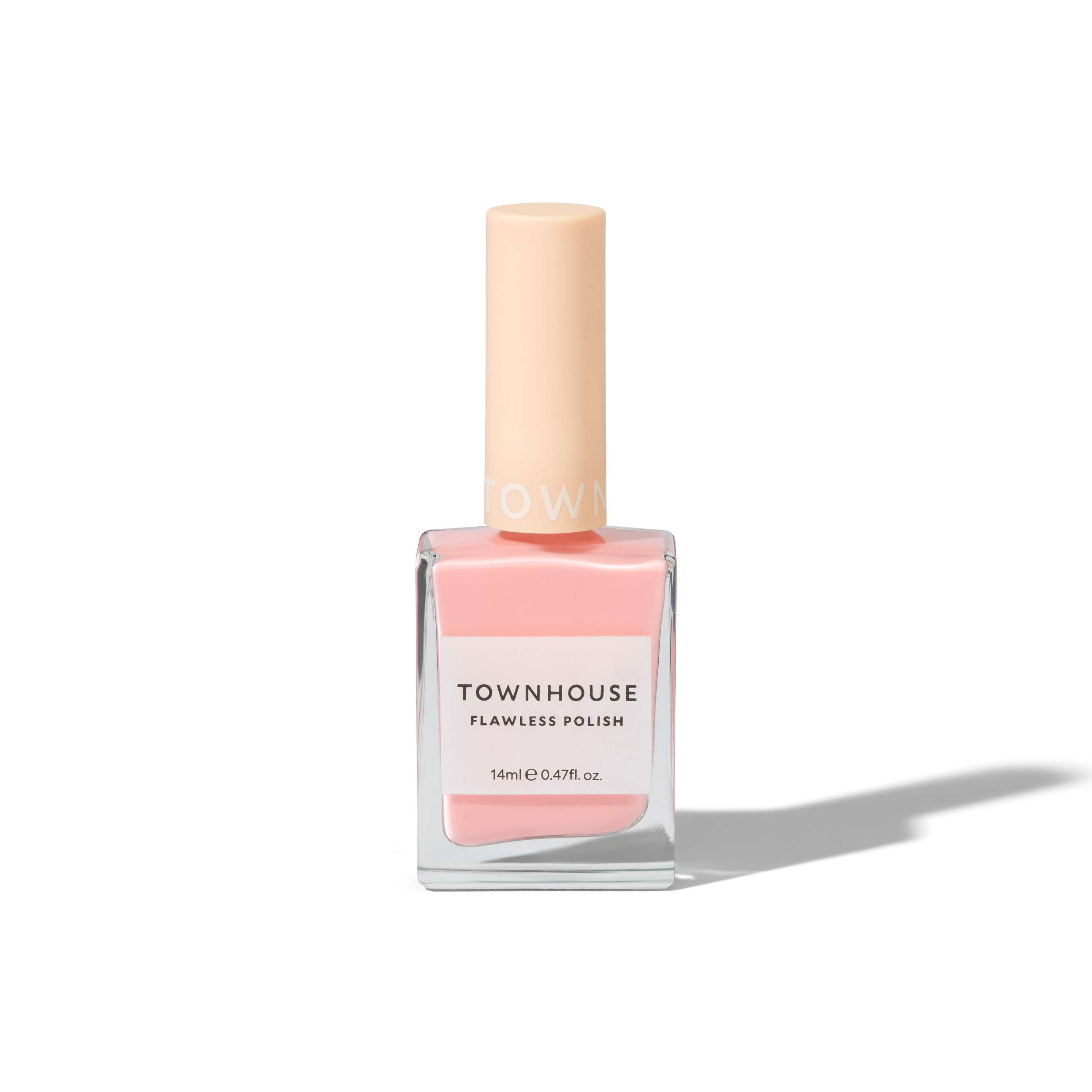 A bottle of TH - Strawberry Meringue Polish 14ml, featuring a soft pink shade, with a square glass base and a matte peach-colored cap, casting a soft shadow on a white background.