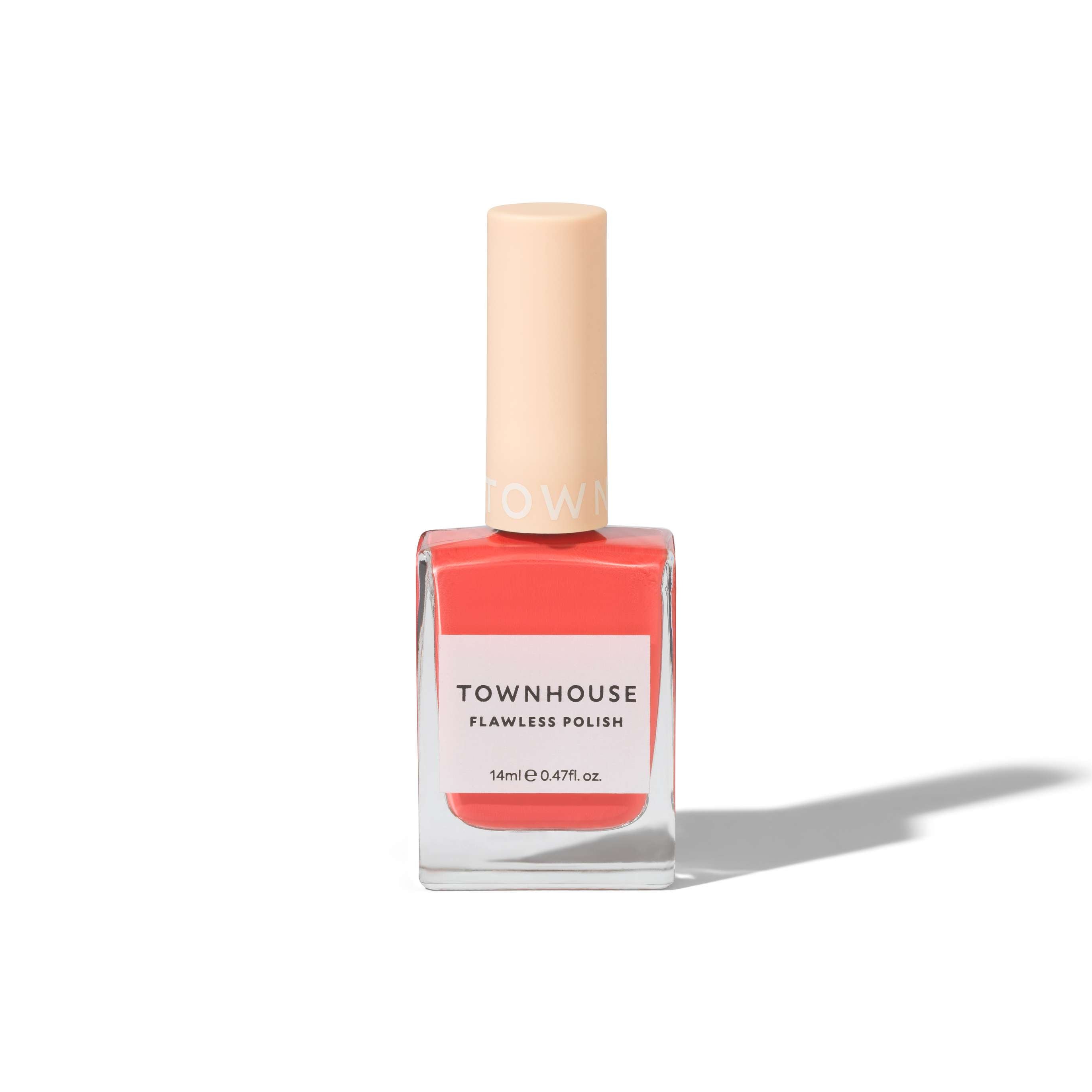A bottle of TH - Apricot Polish 14ml, featuring a peach-pink shade and a beige cap, sits on a white background casting a shadow—perfect as an everyday nail polish or as a base coat to enhance your manicure routine.