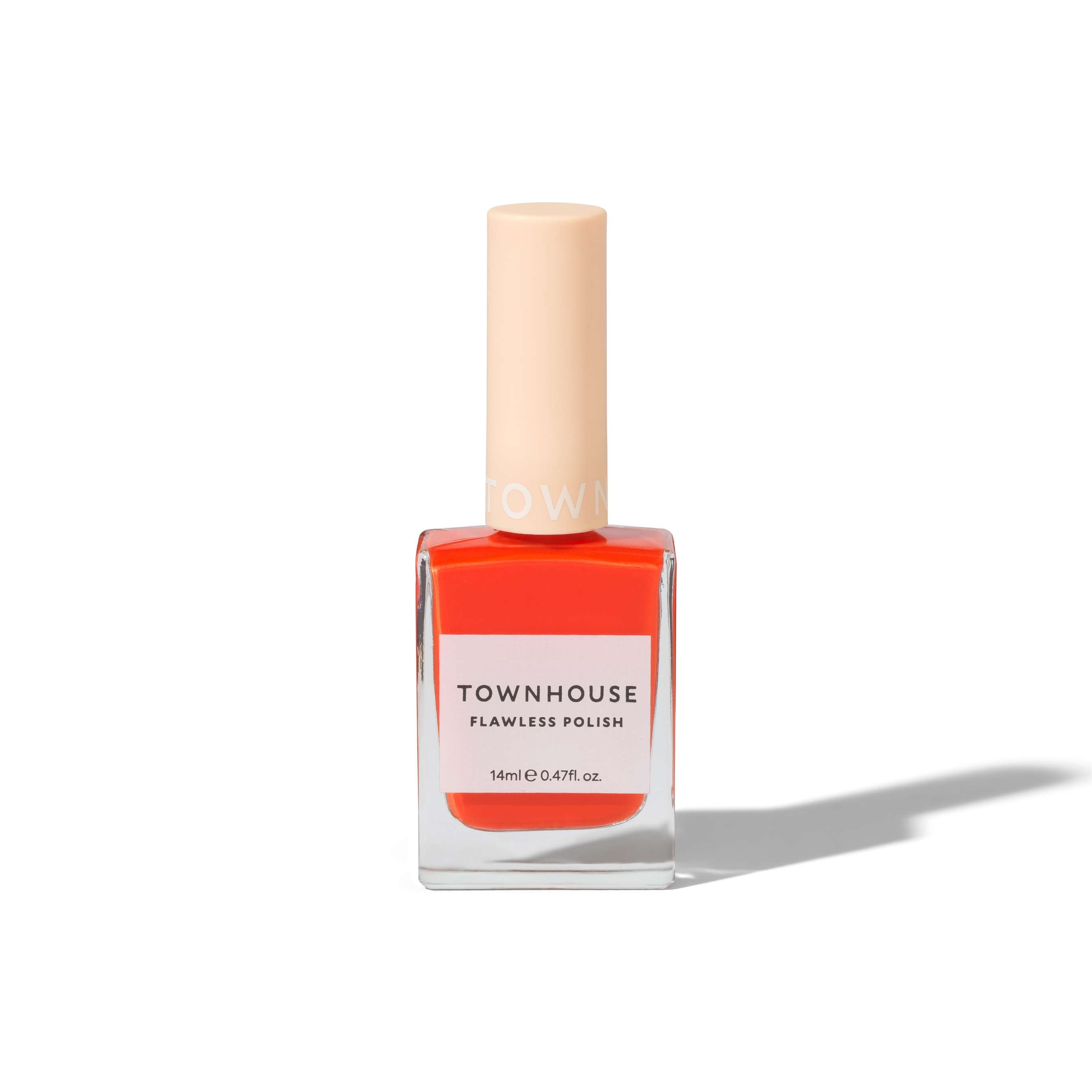 A bottle of TH - Paprika Polish 14ml nail polish in a vibrant coral-orange shade, featuring a cream-colored cap and a glossy finish, displayed on a white background.
