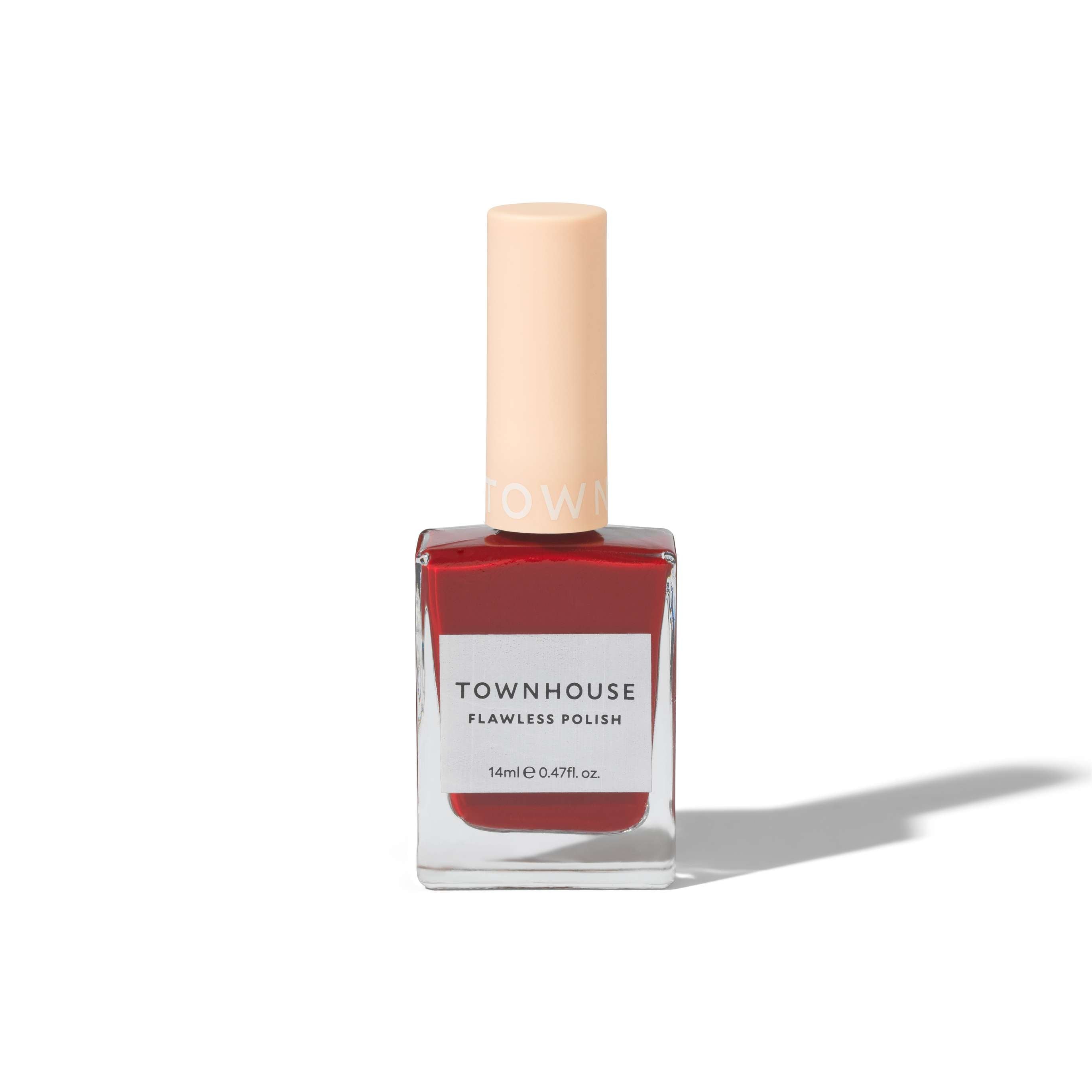A bottle of TH - Red Apple Polish 14ml, featuring classic red nail polish and a beige cap, is displayed against a plain white background.