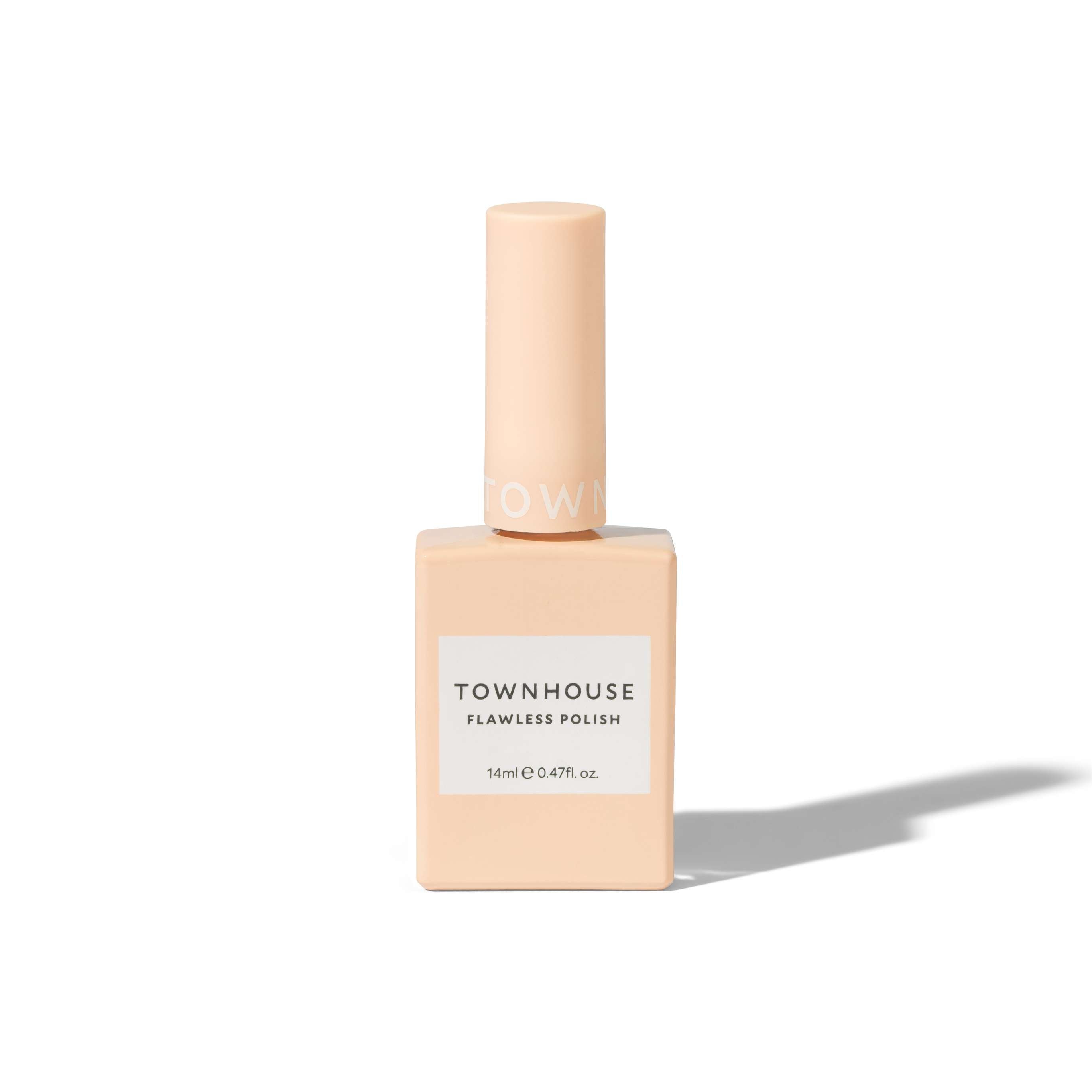 A square, peach-colored bottle of TH - UV Top Coat Polish 14ml with a tall cylindrical cap, displayed against a white background with a shadow to the right. This formula offers chip-resistant properties and provides a mirror-like shine for an effortlessly polished look.